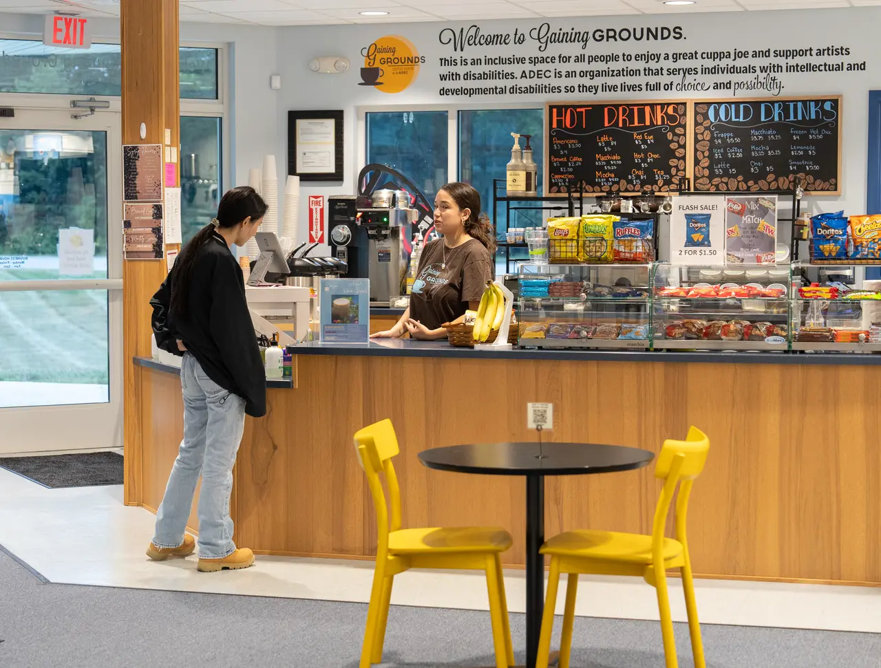 Staff and customer interacting at the Gaining Grounds Coffee House counter