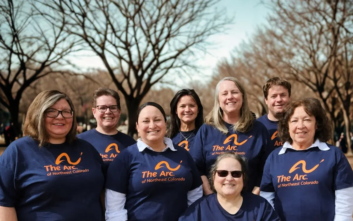 Arc of Northeast Colorado staff in matching Arc shirts posing outdoors