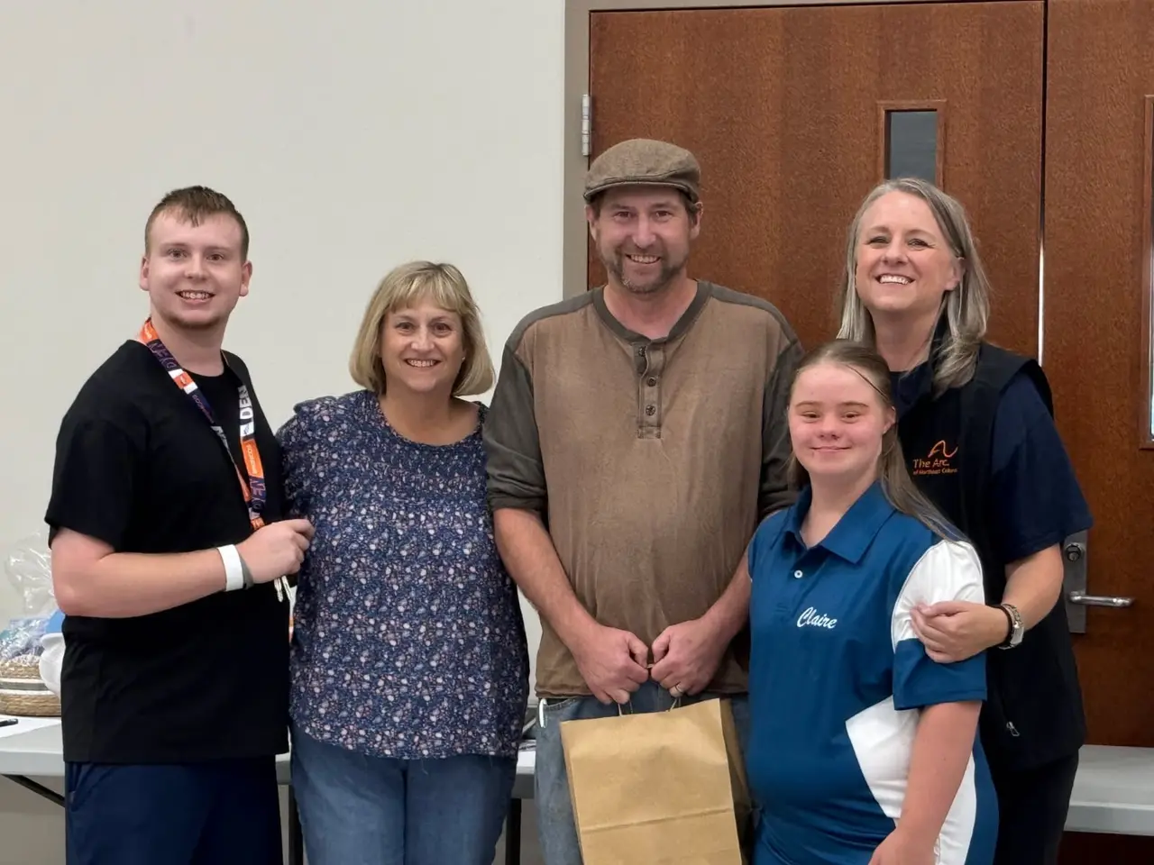 Five people posing together at an Arc of Northeast Colorado event