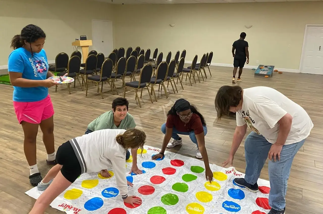 Participants playing a floor game of Twister at the ARC's TIP Community and Event Center