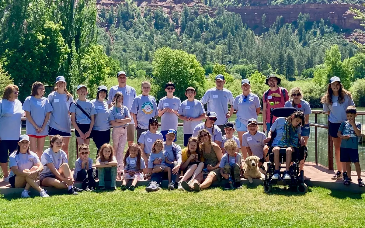 Camp Peak Energy campers, siblings and volunteers gathered for a group photo at River Bend Ranch
