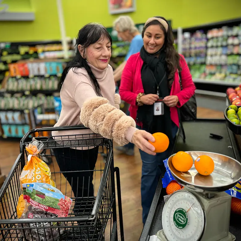 A Desert Arc participant and support specialist working together on an independent living activity