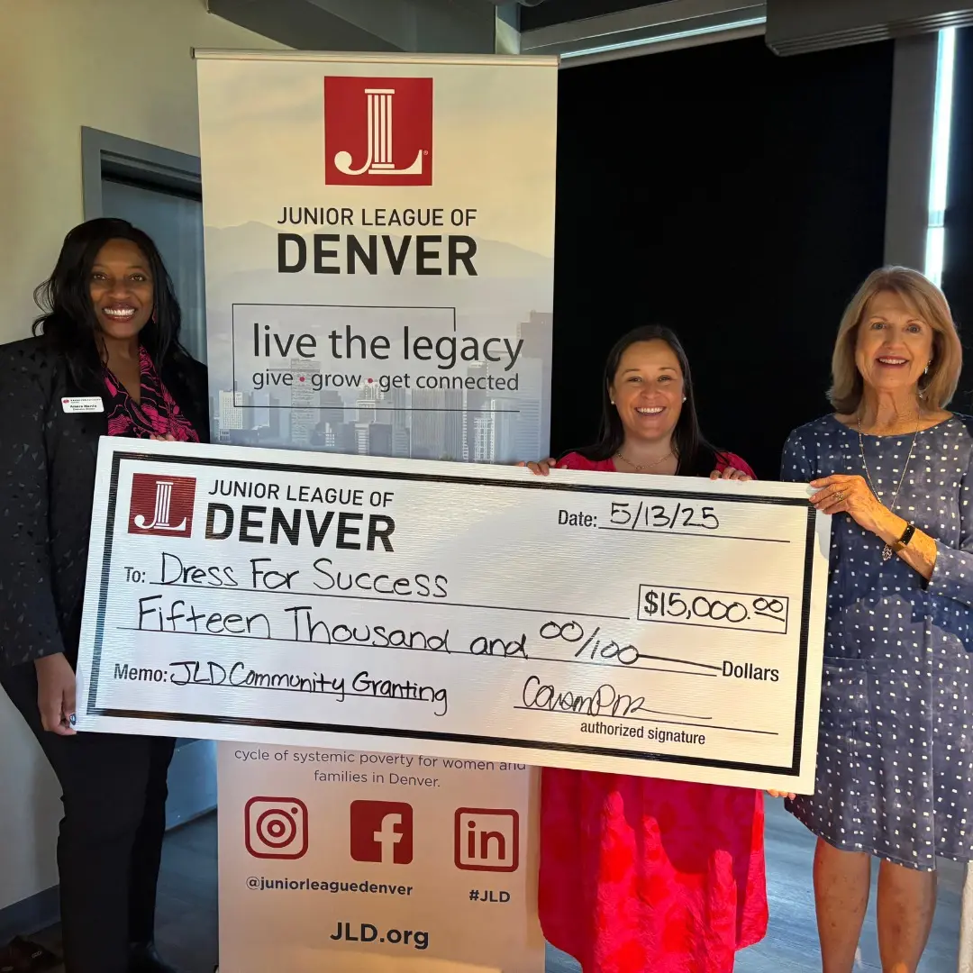Dress for Success Denver representatives receiving a $15,000 Junior League of Denver community grant check in May 2025