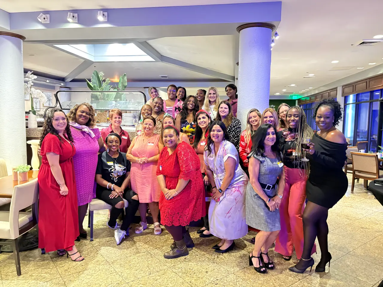 A large group of Dress for Success Palm Beaches women gathered together at a celebration