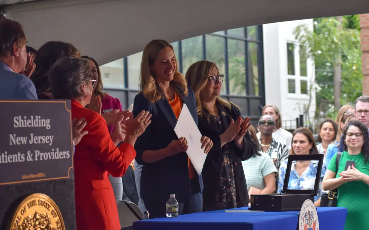 Garden State Equality leaders and community advocates gathered with state officials at a healthcare shield bill signing ceremony