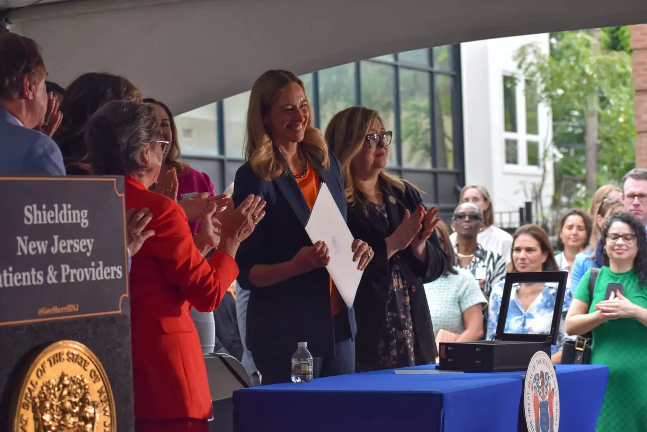 Garden State Equality leaders and community advocates gathered with state officials at a healthcare shield bill signing ceremony