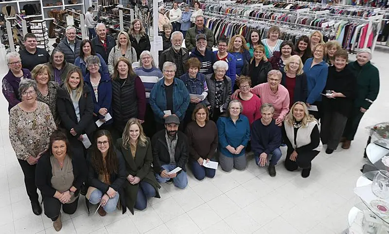 Community supporters, staff, and volunteers gathered together at an indoor celebration