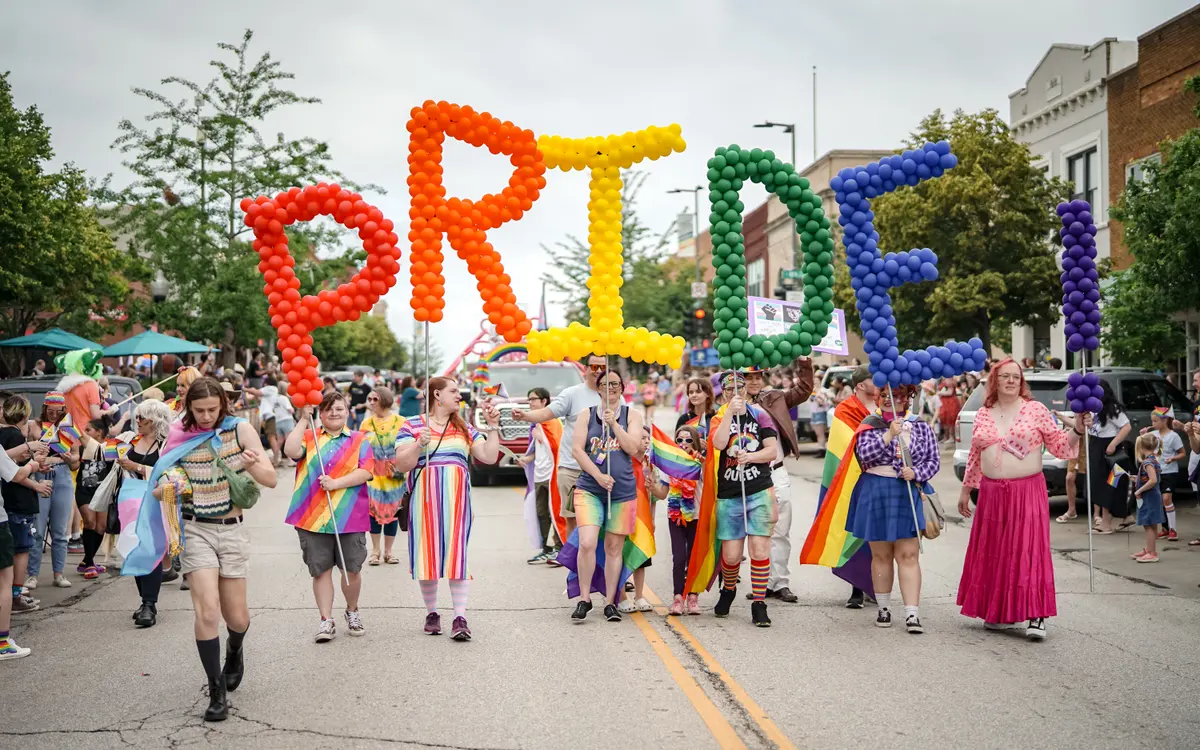 Community participants and supporters celebrating together during the Lawrence Pride festival