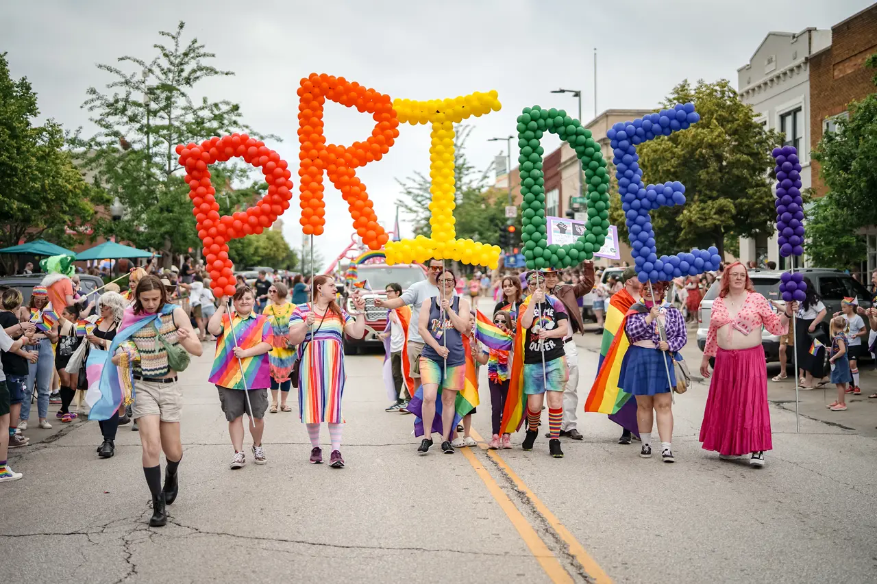 Community participants and supporters celebrating together during the Lawrence Pride festival
