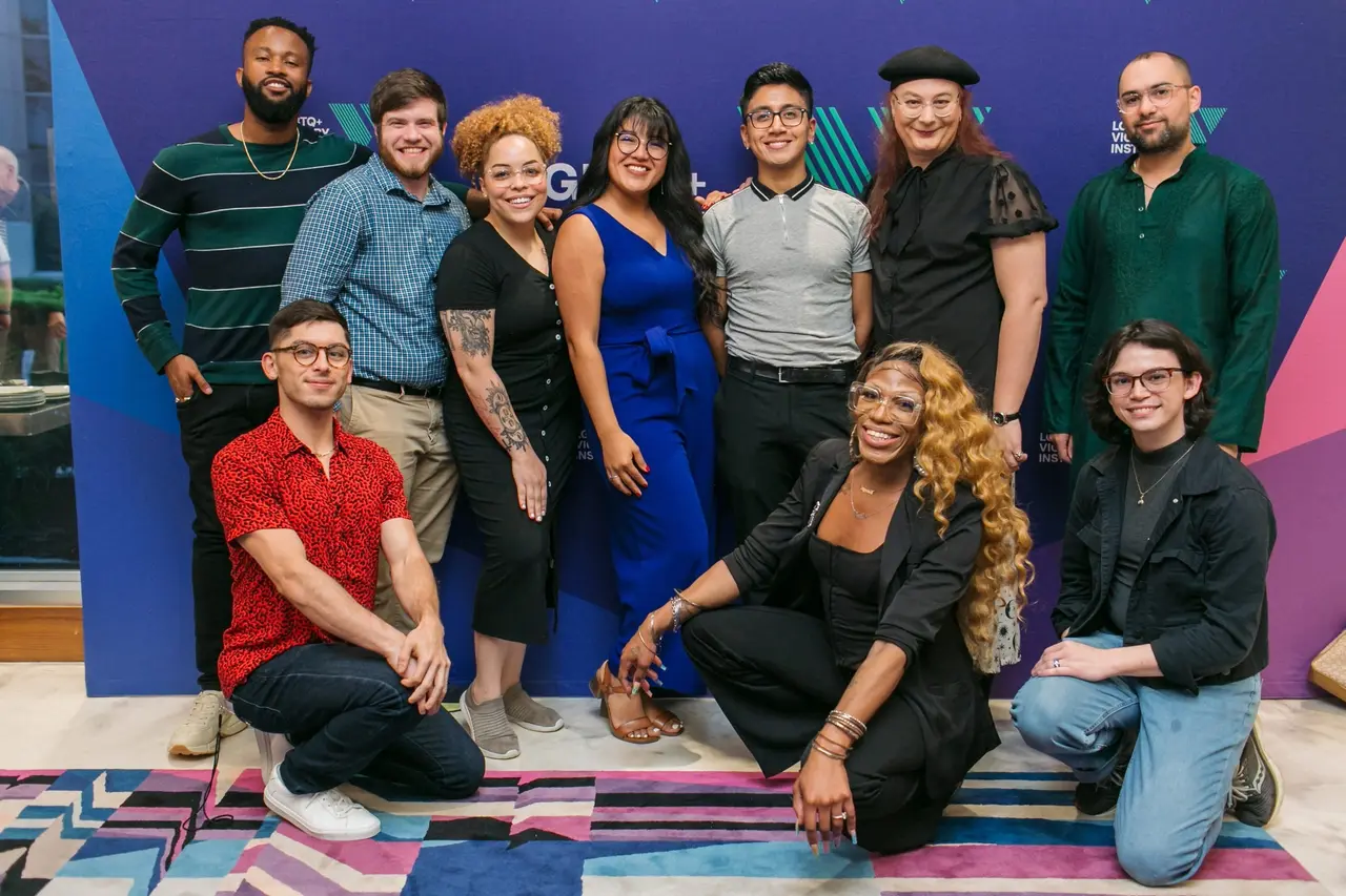 The Victory Empowerment Fellowship class of 2023 posing together in front of a Victory Institute backdrop