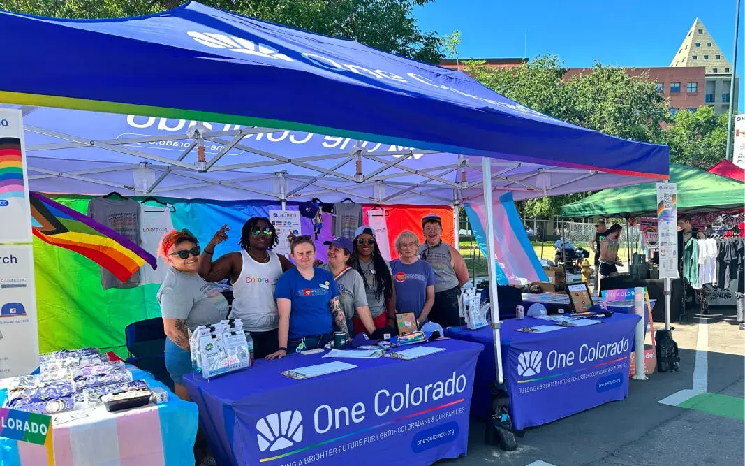 One Colorado staff and volunteers at the organization's booth at a Pride festival