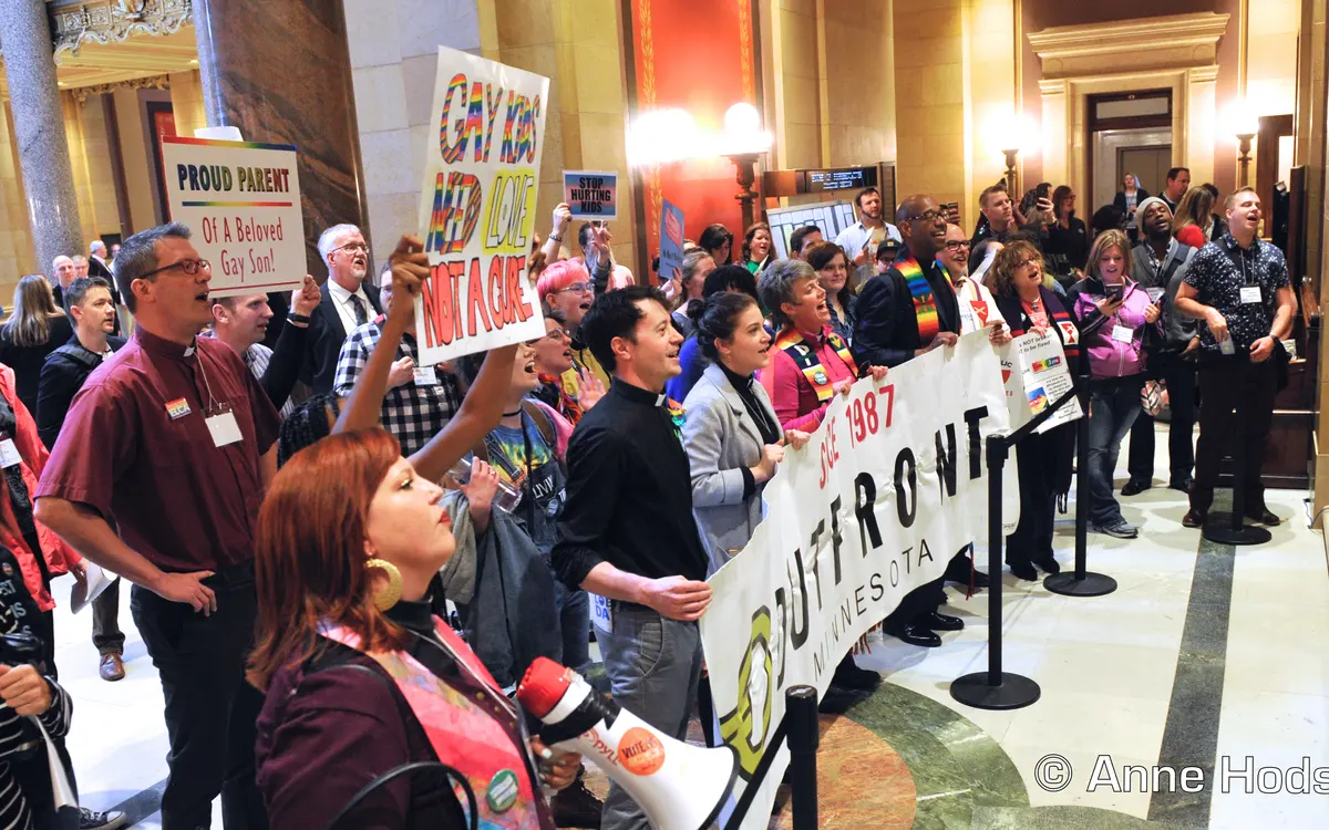 Community members rally for LGBTQ+ equality and human rights at the Minnesota State Capitol