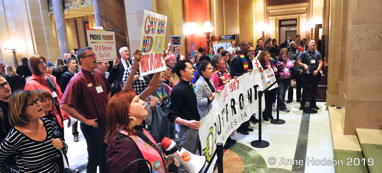 Community members rally for LGBTQ+ equality and human rights at the Minnesota State Capitol