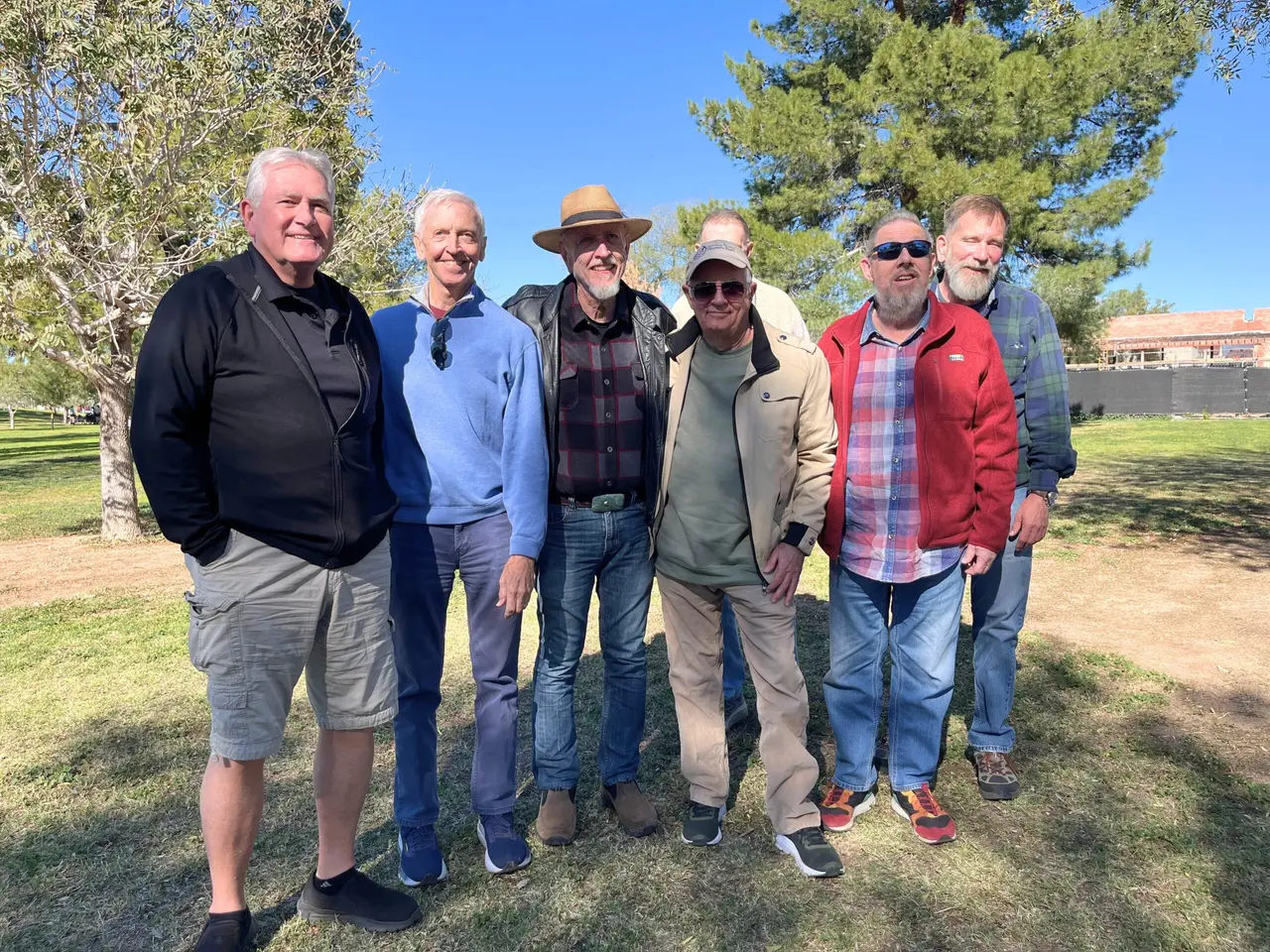 Senior Pride members smiling together at a park gathering in Tucson