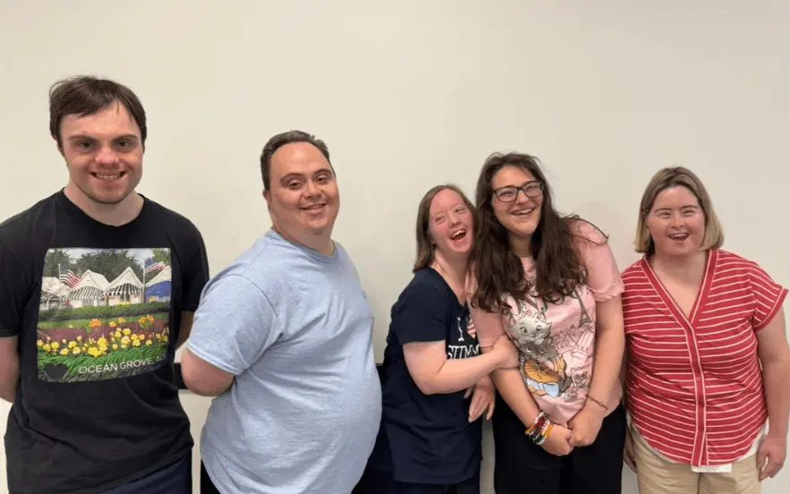 Program participants smiling together during an activity at The Arc, Ocean County Chapter