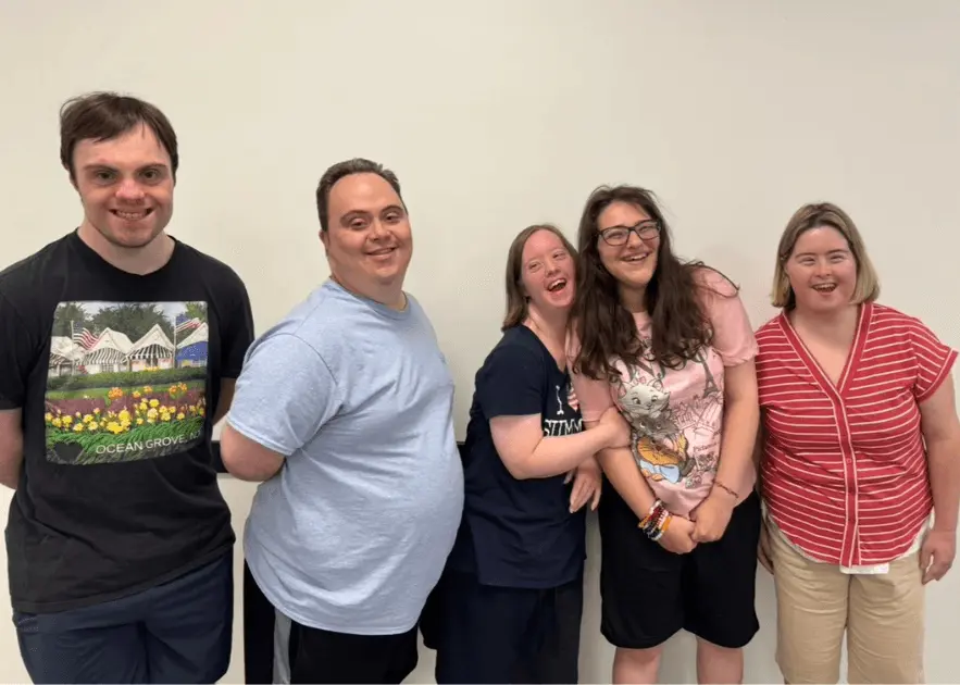 Program participants smiling together during an activity at The Arc, Ocean County Chapter