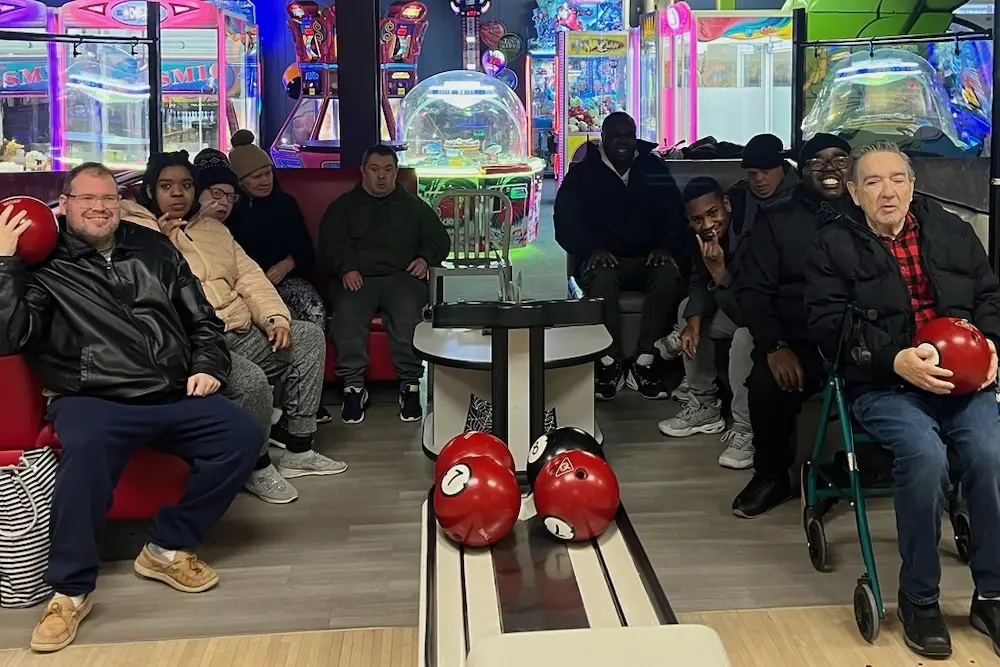 Day habilitation participants enjoying a bowling outing together