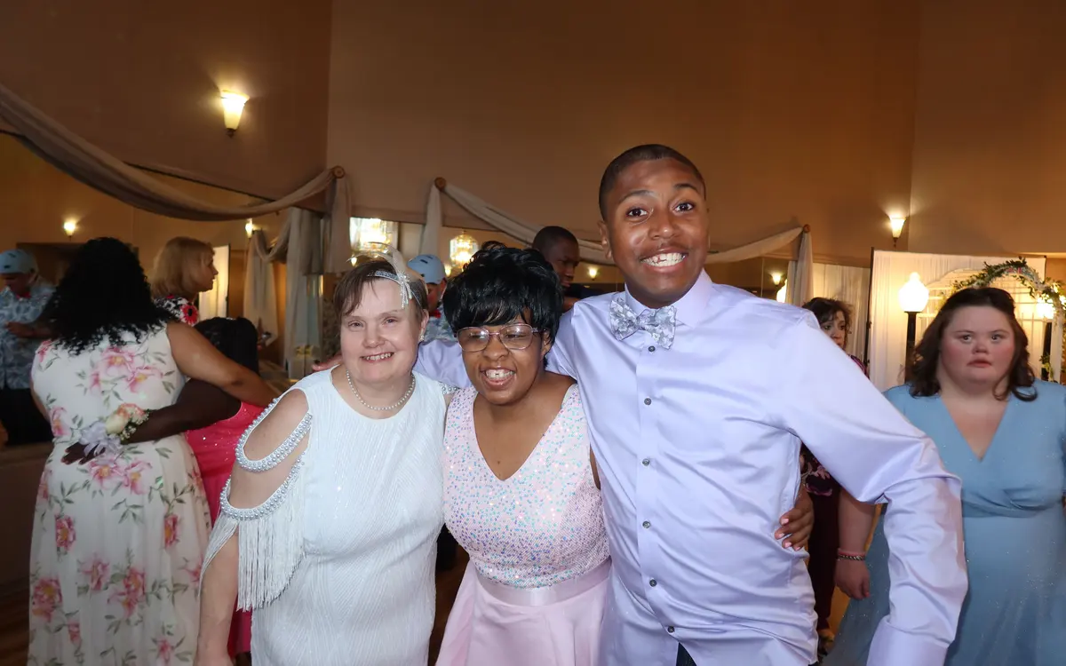 Two people smiling and hugging during an Arc of Burlington County gathering