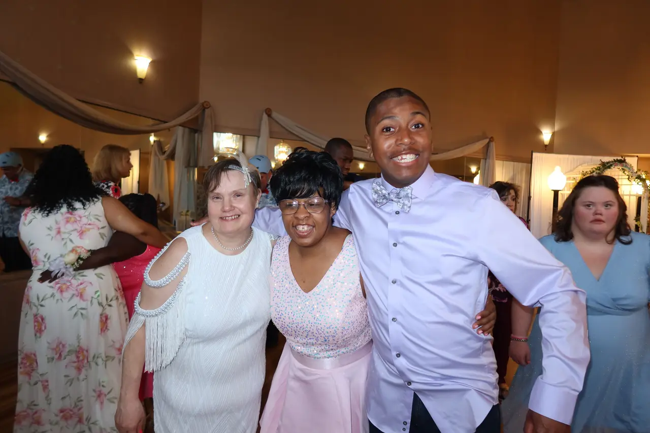 Two people smiling and hugging during an Arc of Burlington County gathering