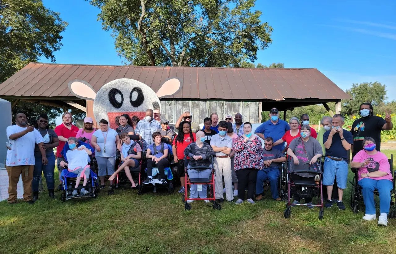 Participants and staff of The Arc of Southwest Georgia gathered outdoors for a group photo