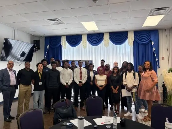 Young people and adults gathered for a group photo at an Urban League of the State of Arkansas event
